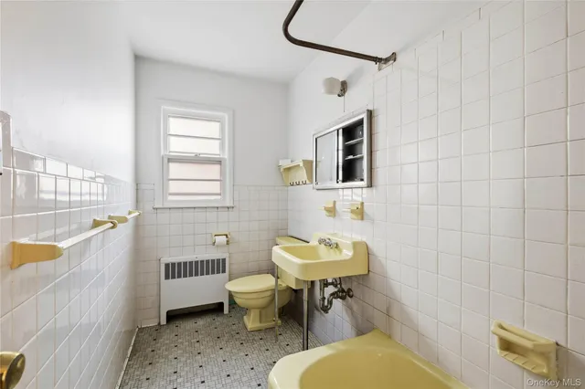 a bathroom with a sink toilet a mirror and shower