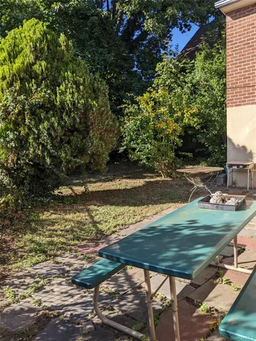 a view of yard with wooden deck and lake view
