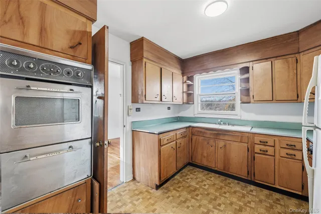 a kitchen with a sink stove and cabinets