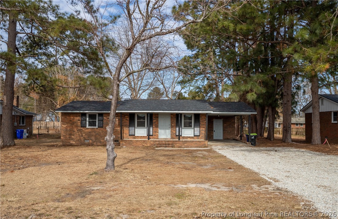 a front view of a house with a tree