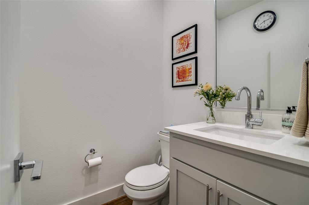 5602 Lindell Avenue, Unit B Dallas, TX 75206 - Photo 13 of 29 a bathroom with a sink mirror vanity and toilet
