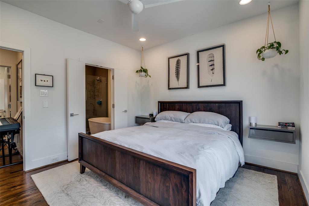 5602 Lindell Avenue, Unit B Dallas, TX 75206 - Photo 15 of 29 a bedroom with a bed and a chandelier