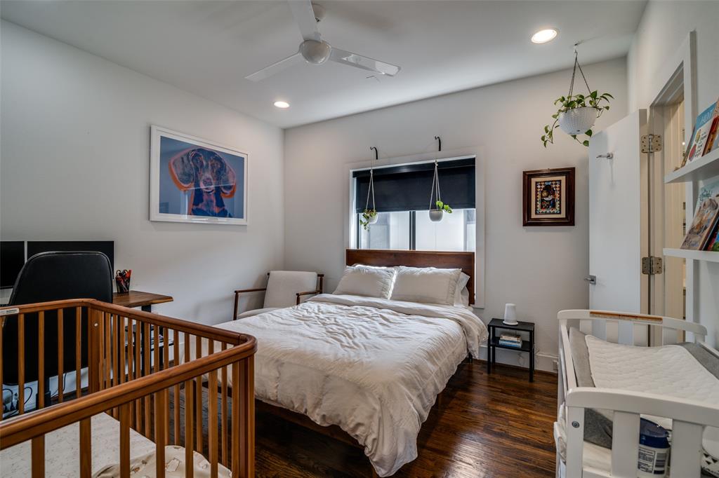 5602 Lindell Avenue, Unit B Dallas, TX 75206 - Photo 21 of 29 a bedroom with bed and a chandelier