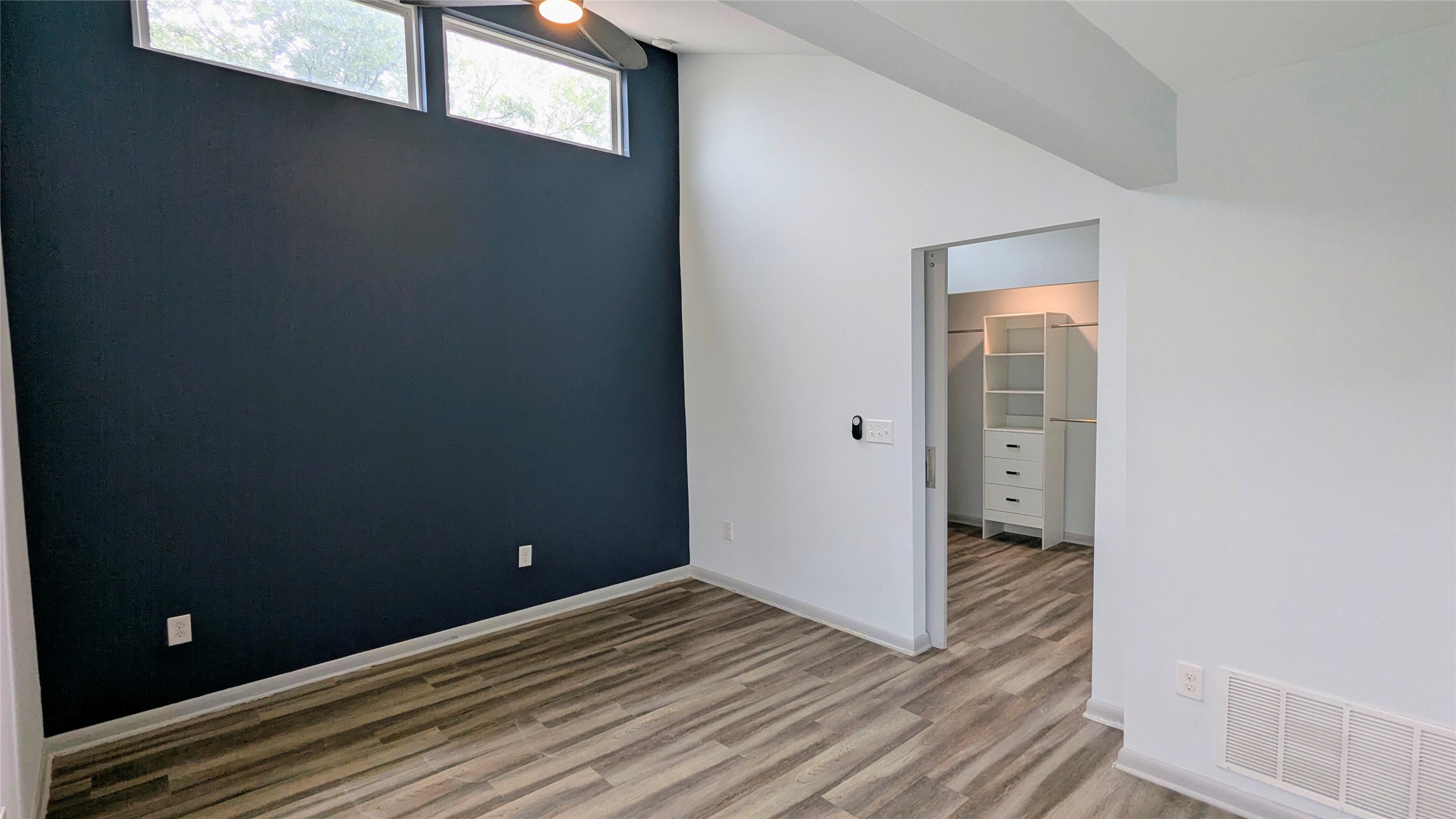 4505 Teri Road, Unit A Austin, TX 78744 - Photo 11 of 23 Natural light streams into this elevated ceiling bedroom, complete with durable plank flooring.