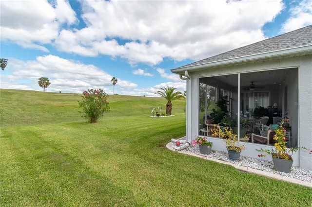 a view of a house with swimming pool and a yard