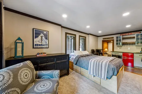 a spacious bedroom with a bed and dresser