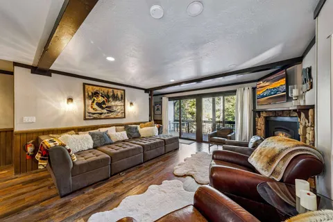 a living room with furniture fireplace and a large window
