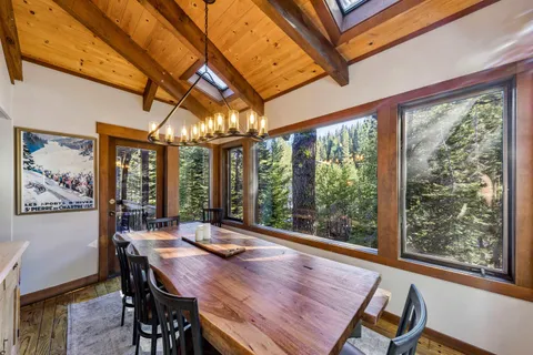 a view of a dining room with furniture large windows and wooden floor