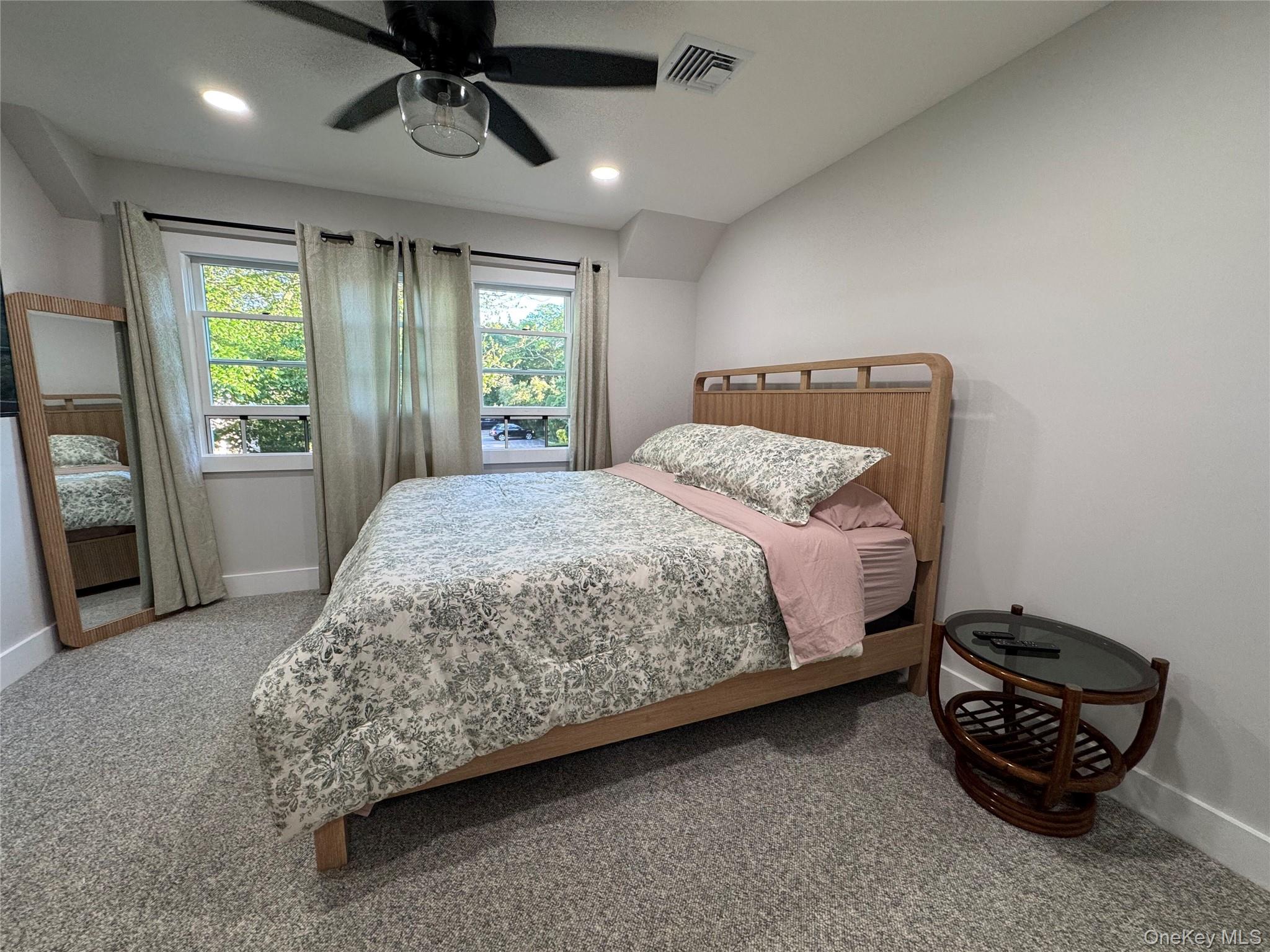 49 Canoe Place Road, Unit 312 Hampton Bays, NY 11946 - Photo 3 of 12 a bedroom with a bed and a window