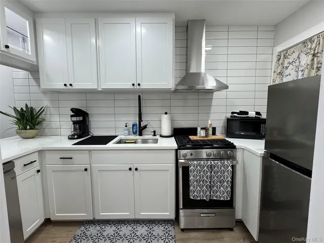 a living room with furniture and a dining table with wooden floor