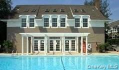 49 Canoe Place Road, Unit 312 Hampton Bays, NY 11946 - Photo 9 of 12 a view of a building with a yard