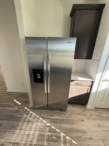 a kitchen with stainless steel appliances a stove a microwave a sink and a refrigerator