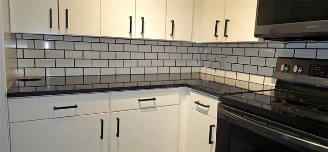 a kitchen with a stove and a cabinets