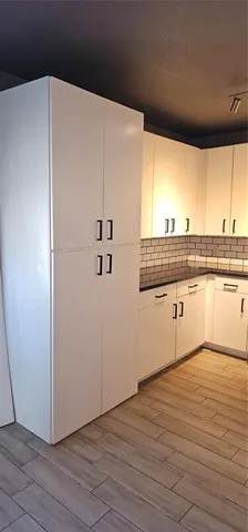 a view of a kitchen with wooden floor