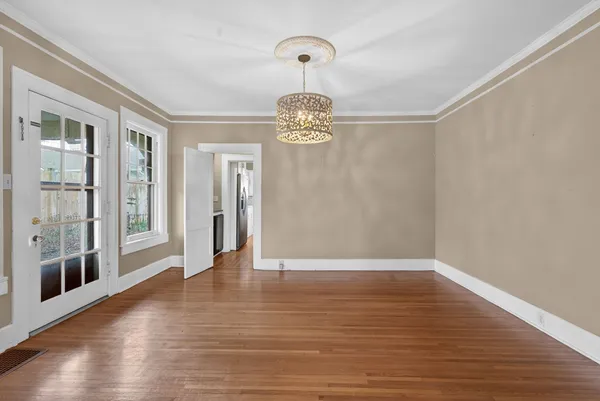 a kitchen with a stove a sink and a wooden floor
