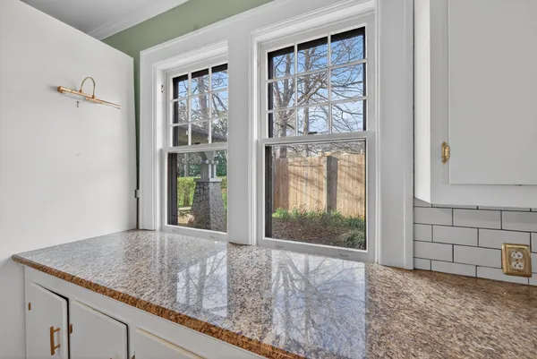 a view of a room with window and hardwood floor