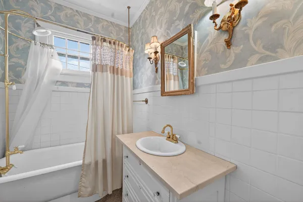 a view of an empty room with stairs and a window