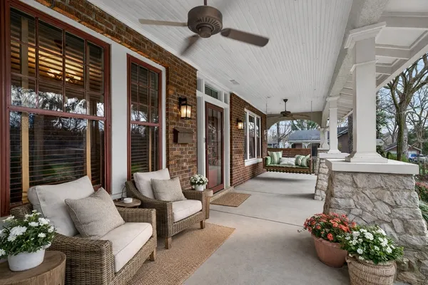 a view of an empty room with wooden floor fireplace and a window