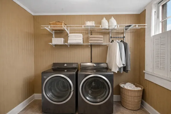 a view of a yard in front of a house with large windows