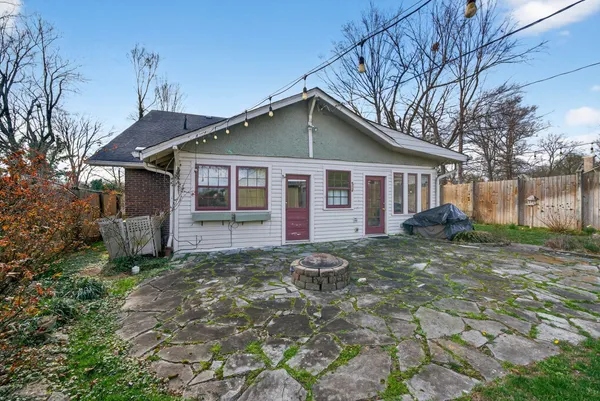 a front view of a house with yard and green space