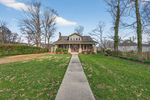 a view of a porch with chairs and potted plants
