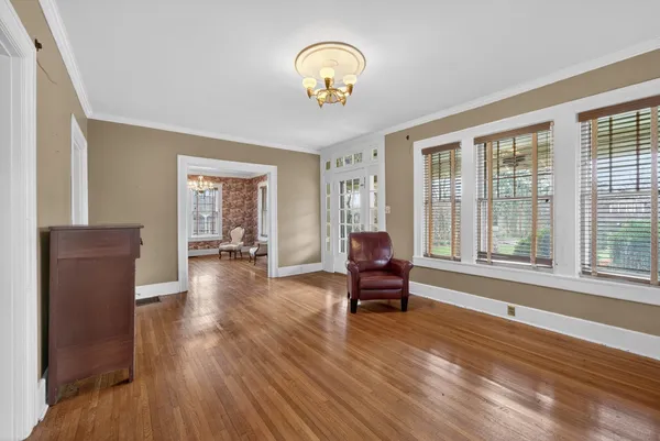 a living room with furniture and a chandelier