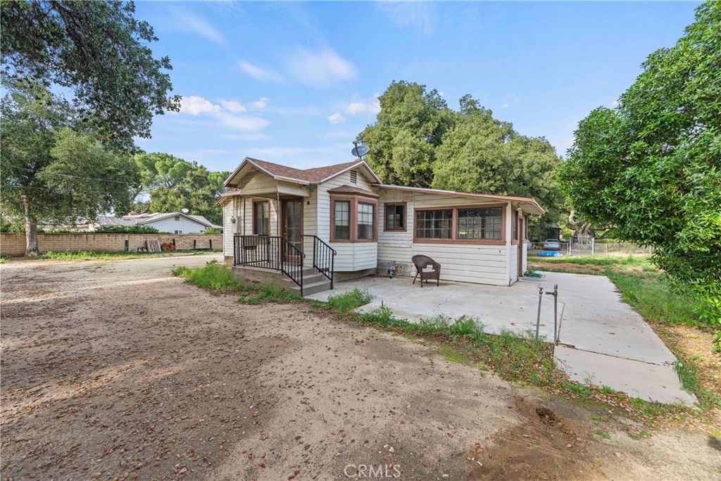 24811 Meadview Avenue Newhall, CA 91321 - Photo 21 of 73 a front view of a house with a yard and potted plants