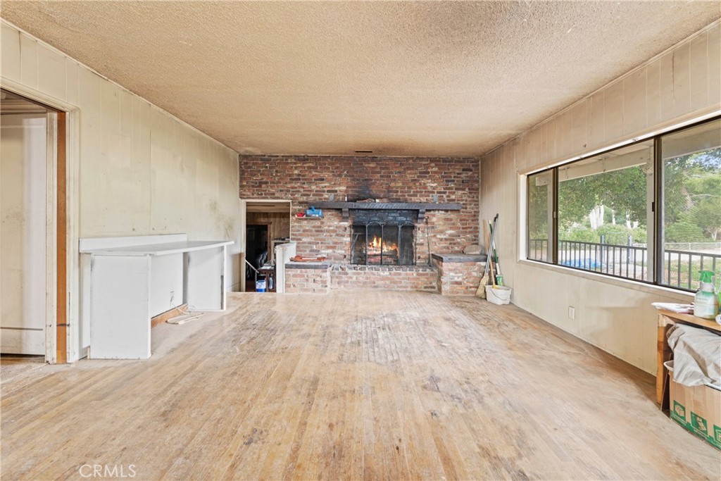 24811 Meadview Avenue Newhall, CA 91321 - Photo 24 of 73 a view of empty room with wooden floor and fireplace