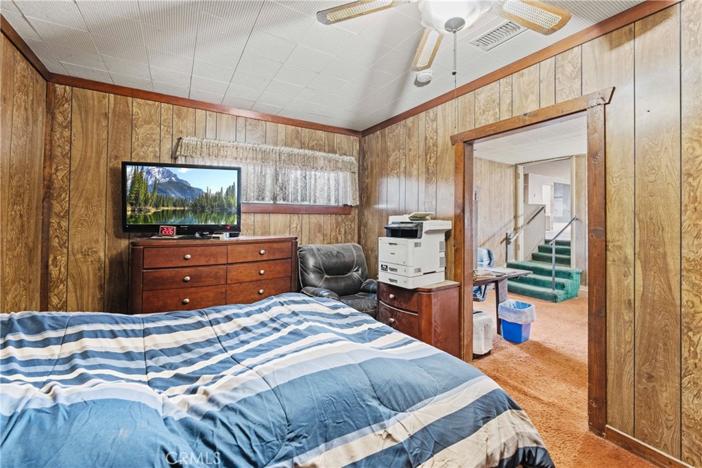 24811 Meadview Avenue Newhall, CA 91321 - Photo 38 of 73 a bedroom with a bed and flat screen tv