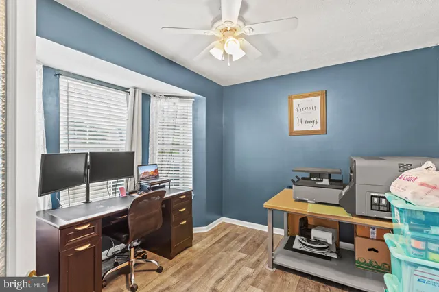 a spacious bedroom with a bed and a chandelier