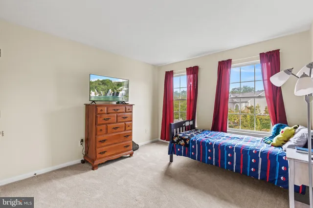 a bedroom with a bed and a table in it