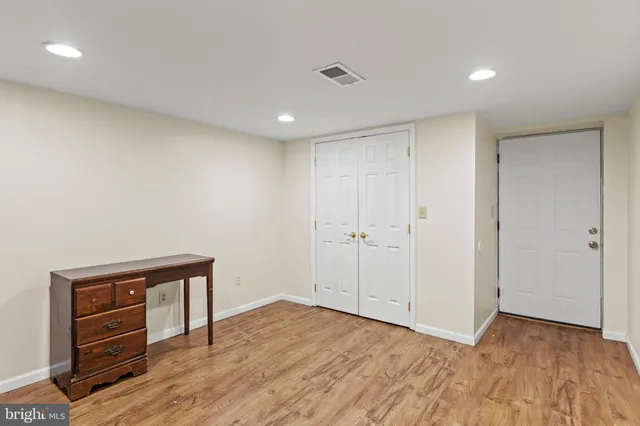 a view of a big yard with table and chairs under an umbrella