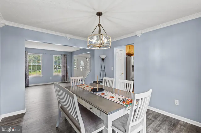 a view of a dining room with furniture and window