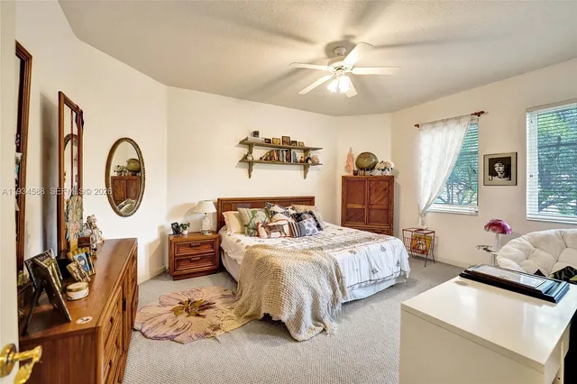 a bedroom with bed and a chandelier