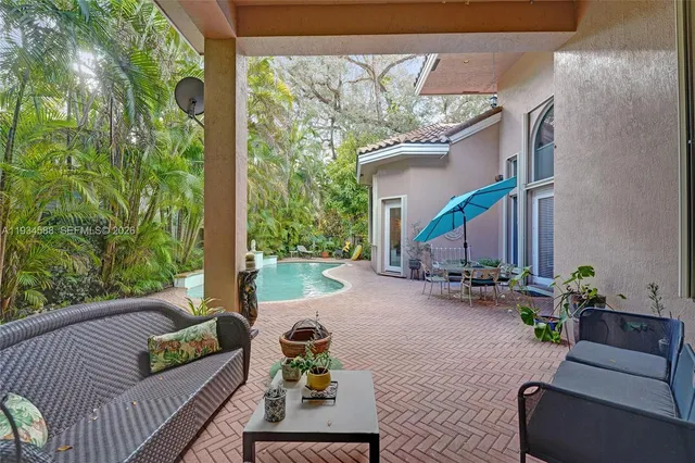 a balcony with furniture and a potted plant