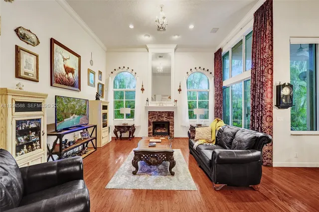 a living room with furniture fireplace and large windows
