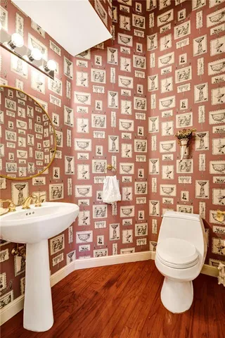 a bathroom with a sink a toilet and shower curtain