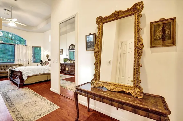 a bedroom with a bed and wooden floor