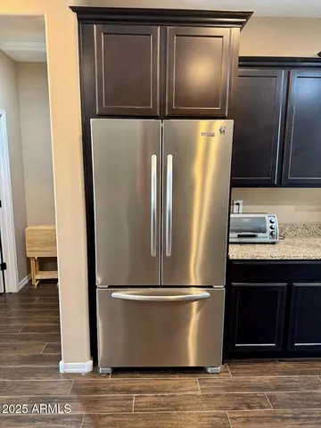 a view of a refrigerator with wooden floor