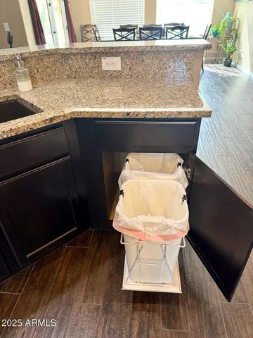 a utility room with granite countertop wooden floor