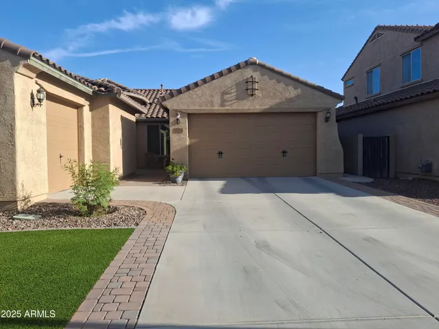 a front view of a house with a yard and garage