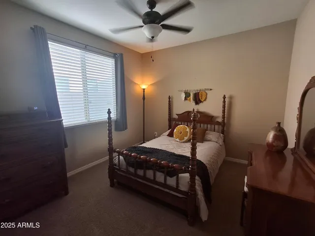 a balcony with table and chairs potted plants and large palm trees
