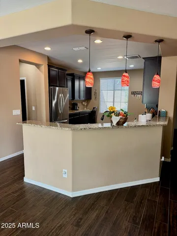 a room with wooden floor table and flat screen tv