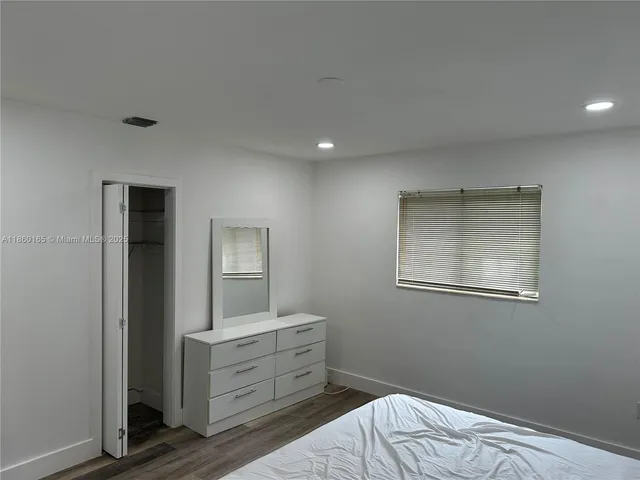 a room with a walk in closet and a mirror