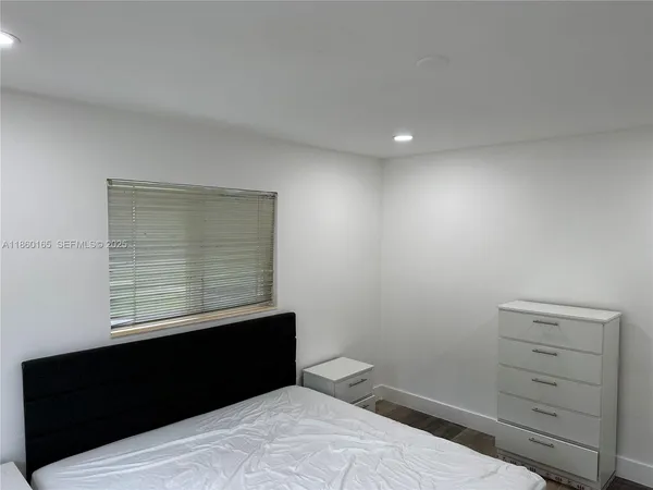 a room with bed and a mirror