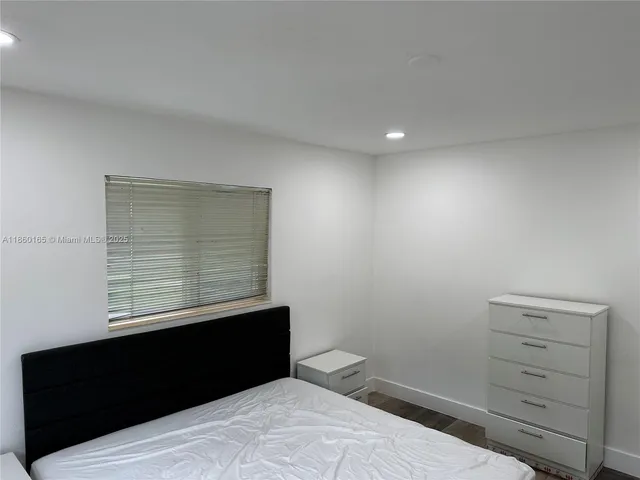 a room with bed and a mirror