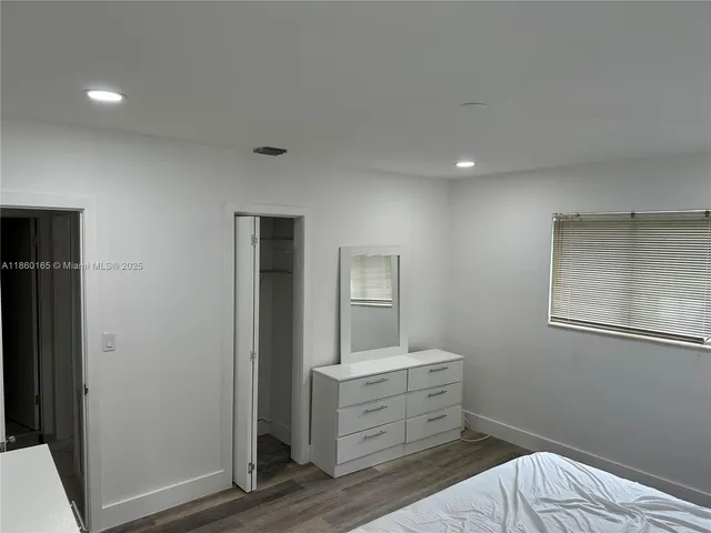 a room with a dresser and mirror