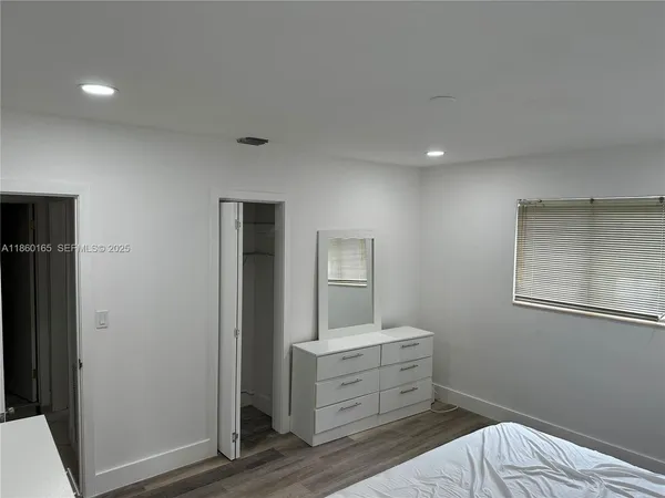 a room with a dresser and mirror