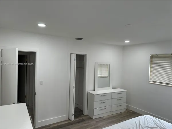 a room with a bed and a mirror