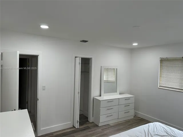 a room with a bed and a mirror